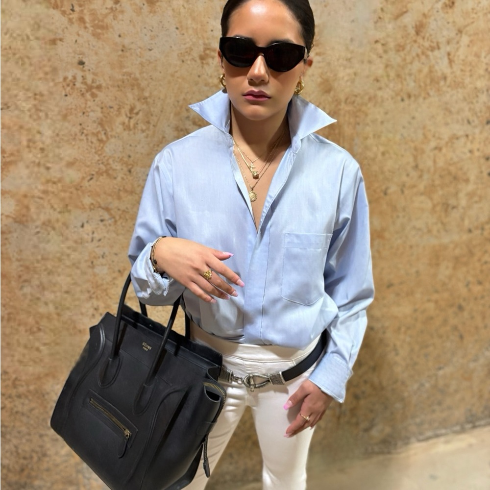 Light Blue Collared Shirt with Black Handbag